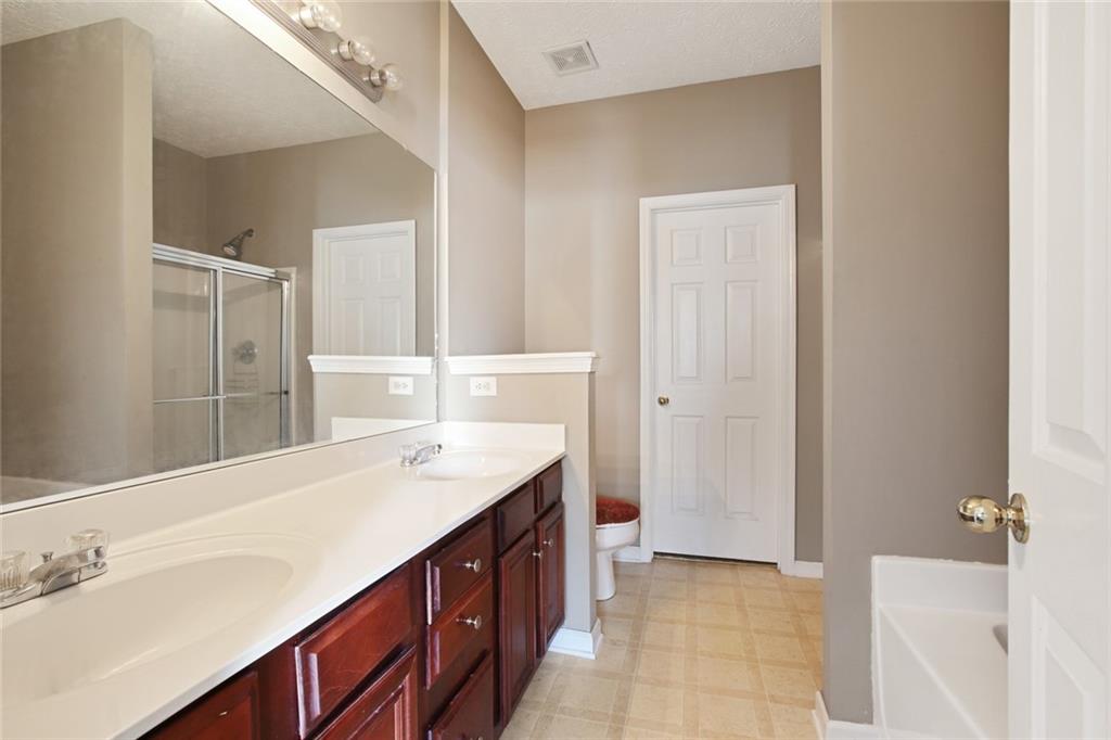2555 Flat Shoals Road, Unit 1801 Atlanta, GA 30349 - Photo 13 of 24 a bathroom with a sink a vanity and a mirror