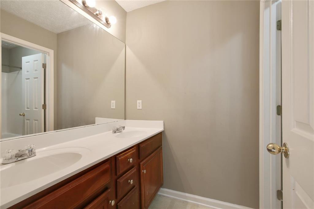 2555 Flat Shoals Road, Unit 1801 Atlanta, GA 30349 - Photo 18 of 24 a bathroom with a sink and a mirror