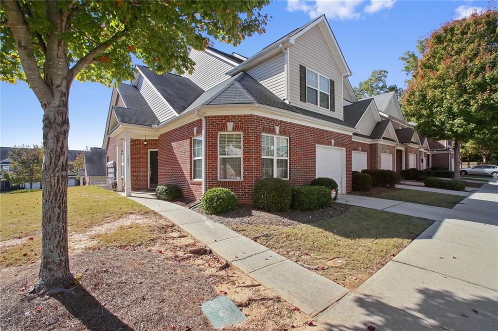 2555 Flat Shoals Road, Unit 1801 Atlanta, GA 30349 - Photo 2 of 24 a front view of a house with garden