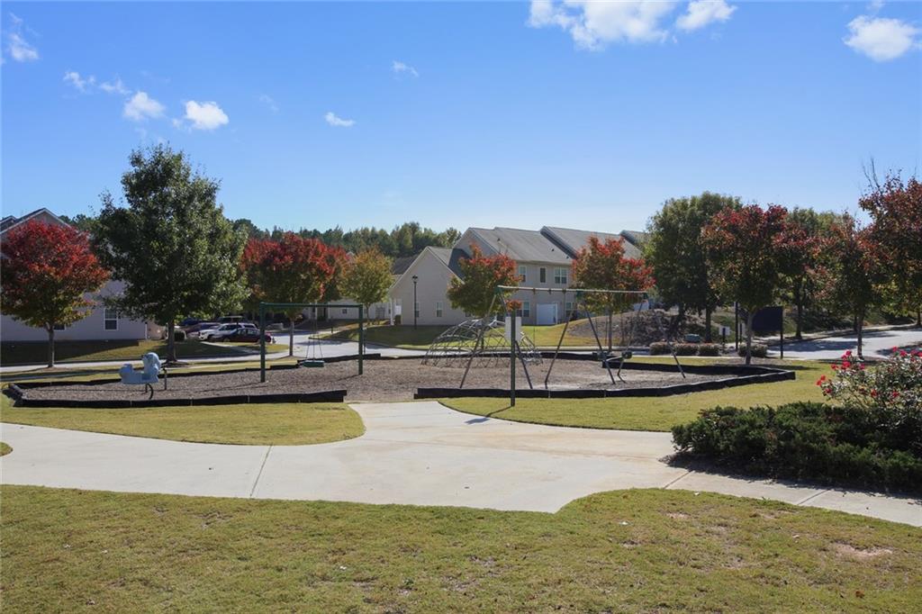 2555 Flat Shoals Road, Unit 1801 Atlanta, GA 30349 - Photo 24 of 24 a view of a swimming pool with an outdoor seating and a yard