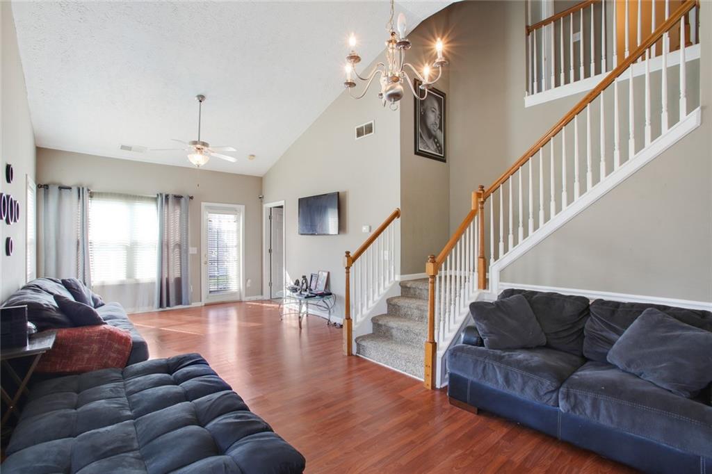 2555 Flat Shoals Road, Unit 1801 Atlanta, GA 30349 - Photo 4 of 24 a living room with furniture and wooden floor
