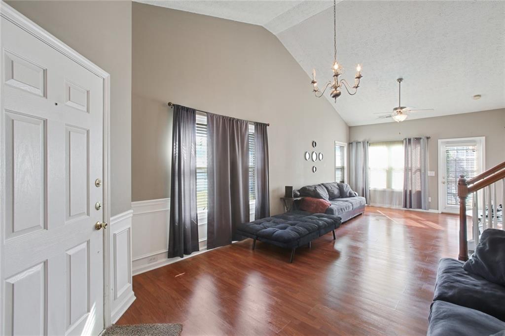 2555 Flat Shoals Road, Unit 1801 Atlanta, GA 30349 - Photo 5 of 24 a living room with furniture and wooden floor