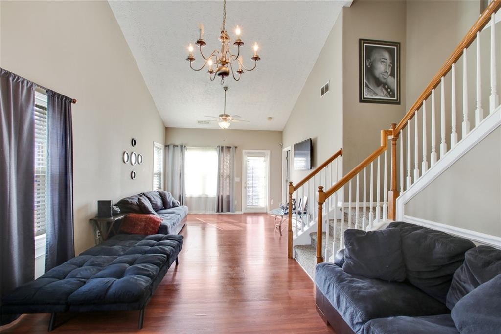 2555 Flat Shoals Road, Unit 1801 Atlanta, GA 30349 - Photo 6 of 24 a living room with furniture chandelier and a chandelier
