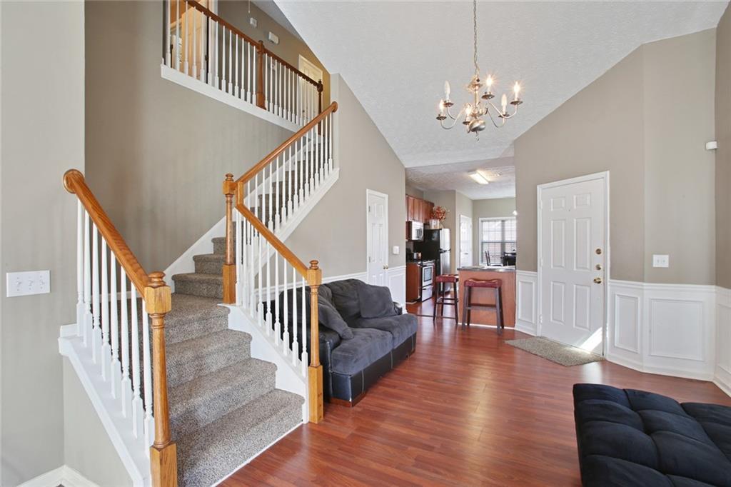 2555 Flat Shoals Road, Unit 1801 Atlanta, GA 30349 - Photo 8 of 24 a view of a livingroom with furniture stairs wooden floor and windows