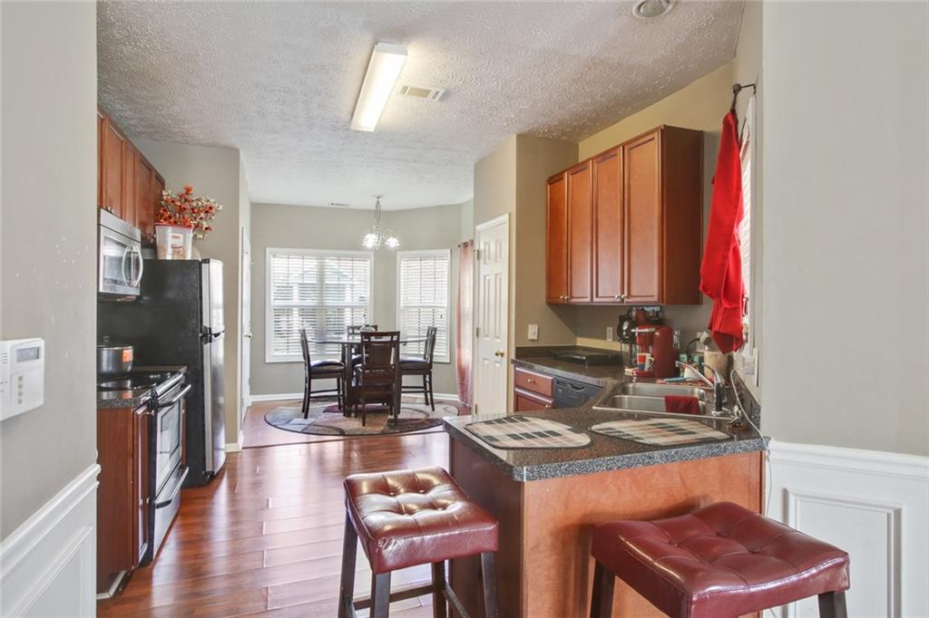 2555 Flat Shoals Road, Unit 1801 Atlanta, GA 30349 - Photo 9 of 24 a kitchen with a stove and a refrigerator