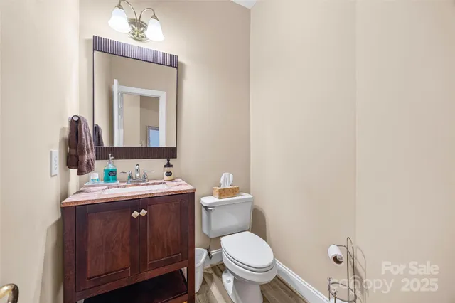 a bathroom with a toilet a sink and mirror