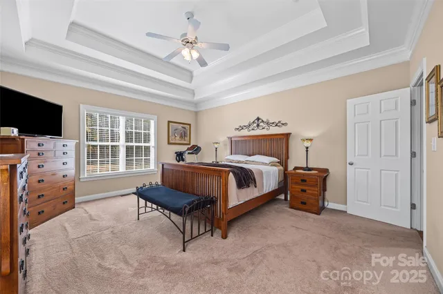 a bedroom with a bed and a flat tv screen on the dresser