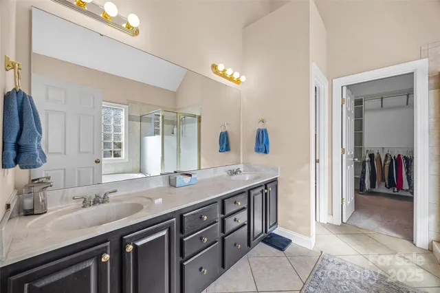 a bathroom with double sink and a mirror