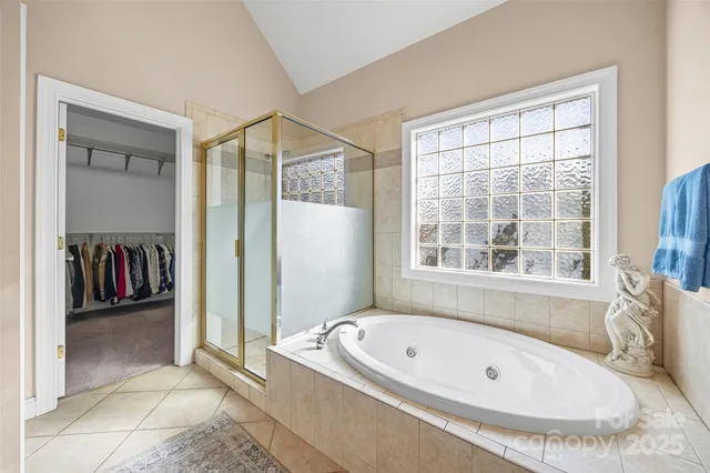 a bathroom with a tub and a window