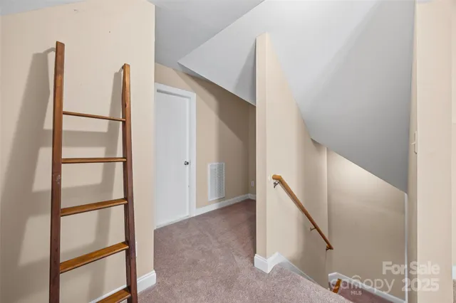a view of staircase with white walls and window