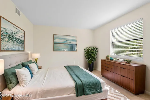 a bedroom with a large bed and a window