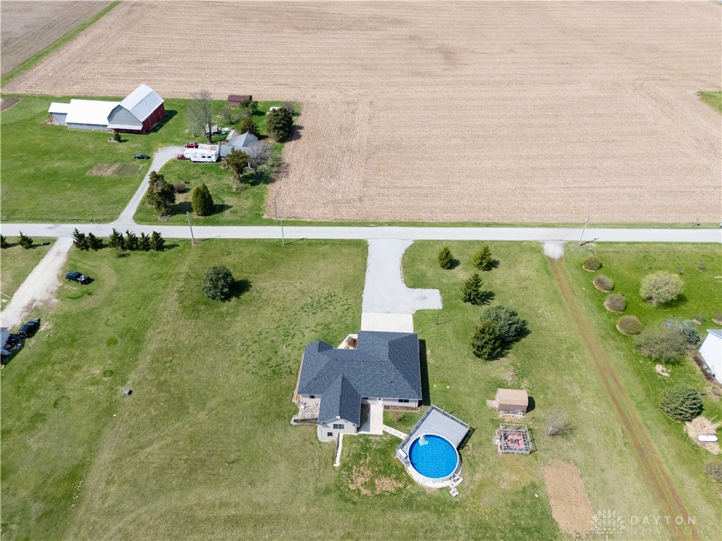 5264 Frazier-Guy Road Sidney, OH 45365 - Photo 50 of 51 An aerial view showcases a residential property nestled amidst expansive fields, complete with an inviting above-ground pool.