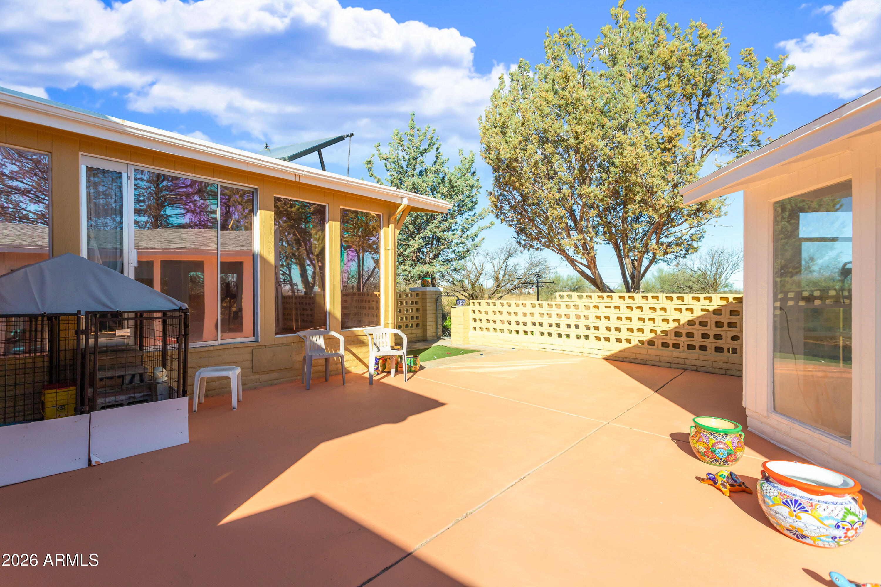 5681 South Moson Road Hereford, AZ 85615 - Photo 14 of 47 a backyard of a house with barbeque oven table and chairs