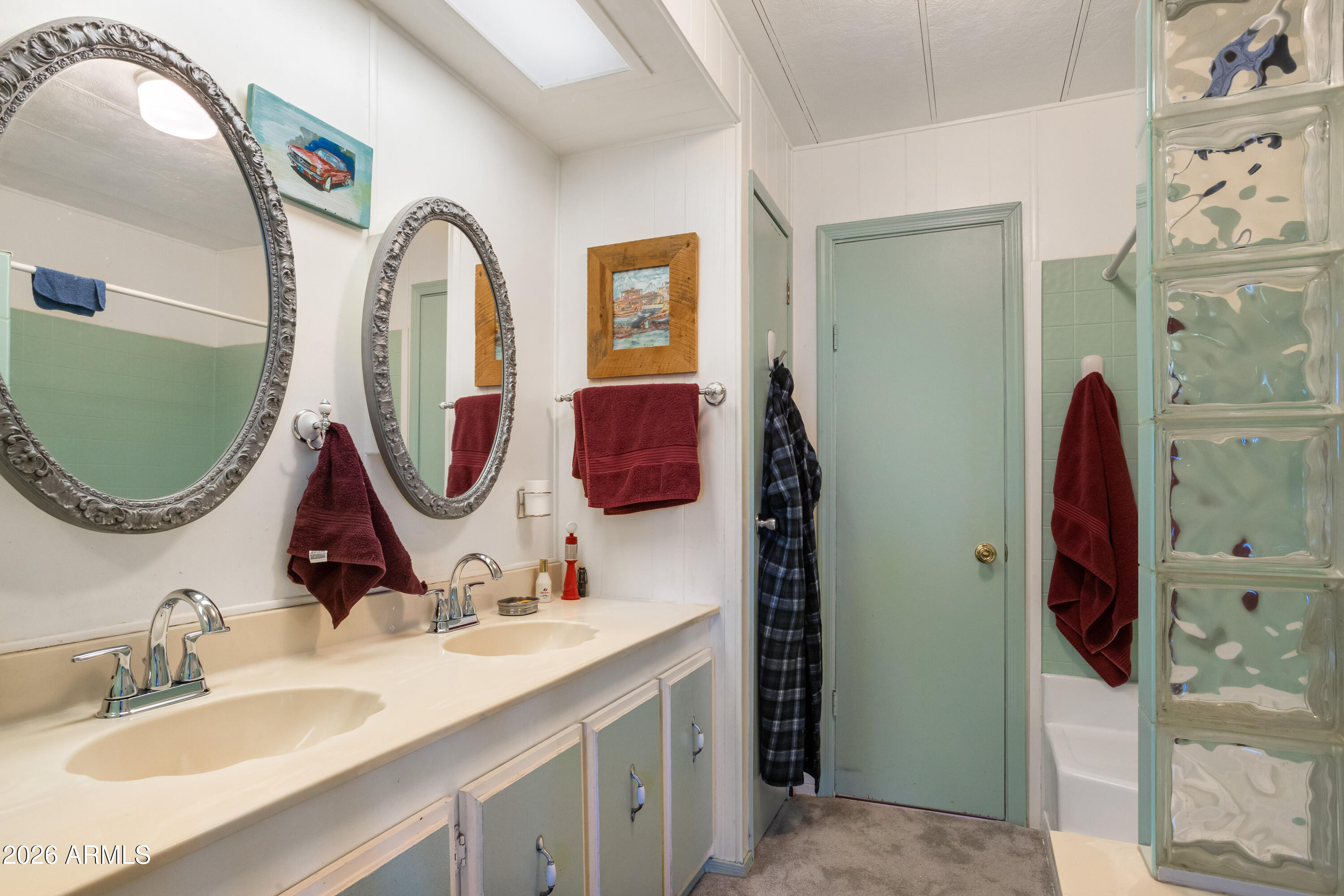 5681 South Moson Road Hereford, AZ 85615 - Photo 27 of 47 a bathroom with a double vanity sink and a mirror