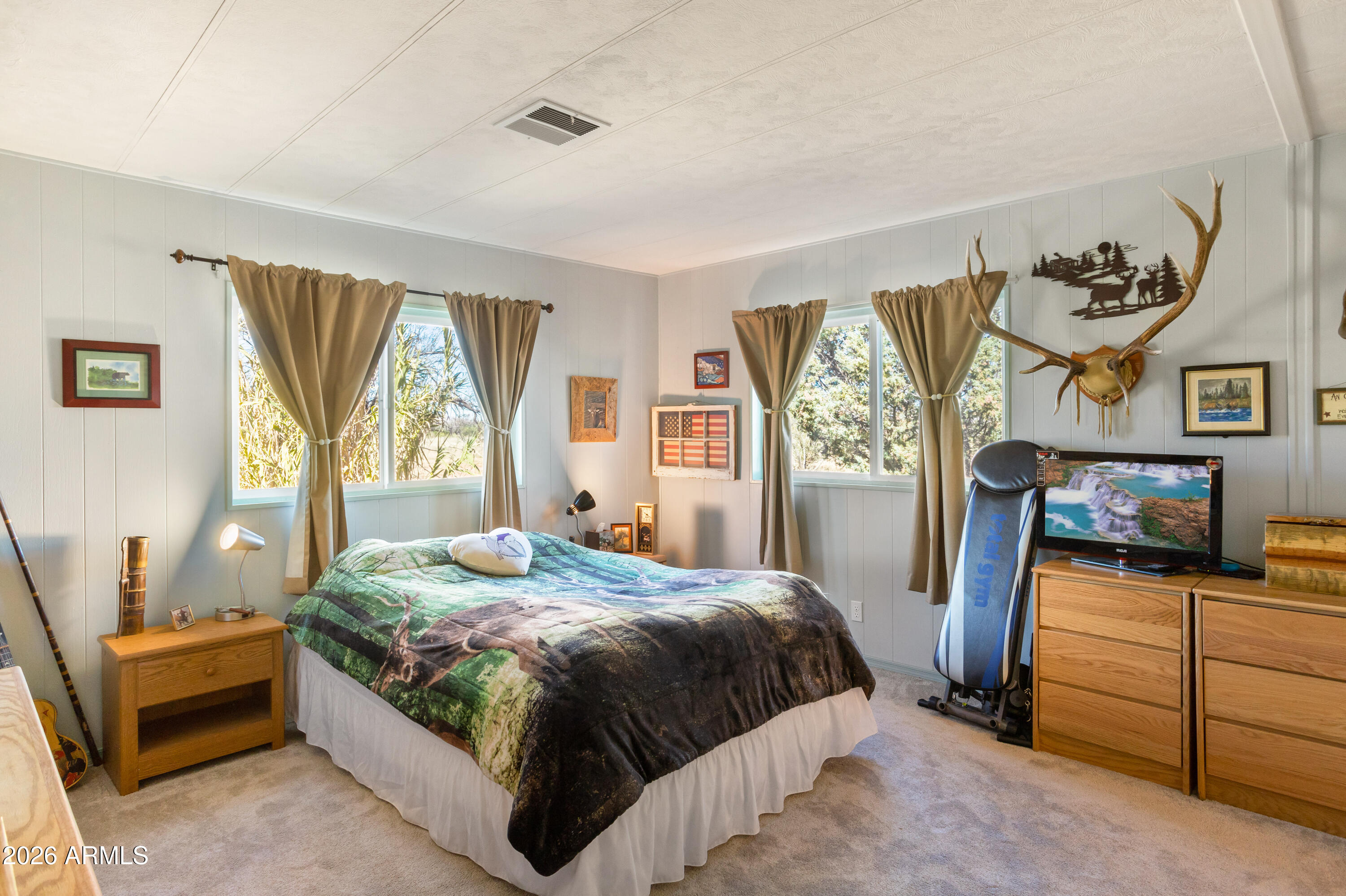 5681 South Moson Road Hereford, AZ 85615 - Photo 29 of 47 a bedroom with a bed and a flat tv screen