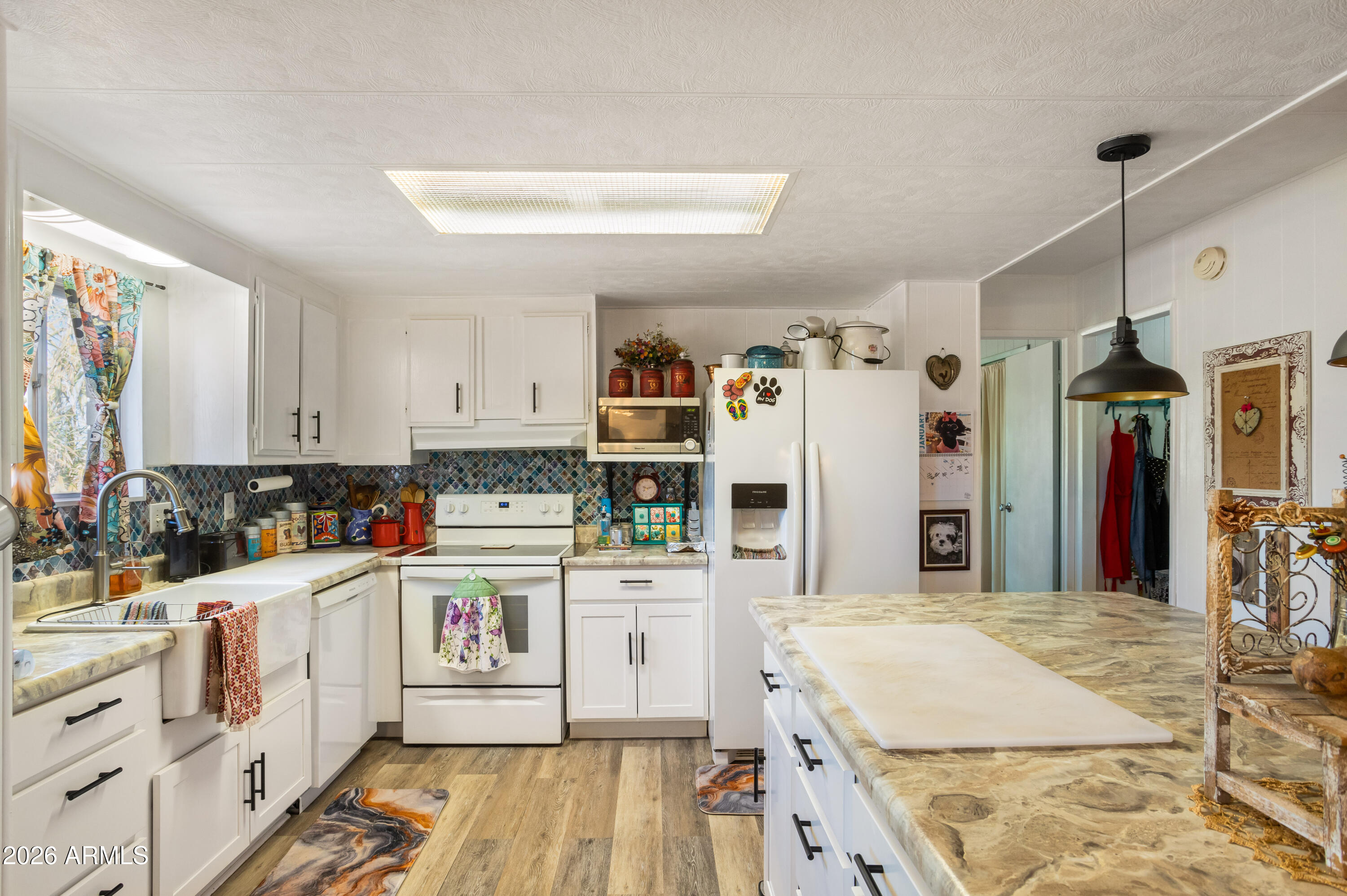 5681 South Moson Road Hereford, AZ 85615 - Photo 31 of 47 a kitchen that has a lot of white cabinets and stainless steel appliances