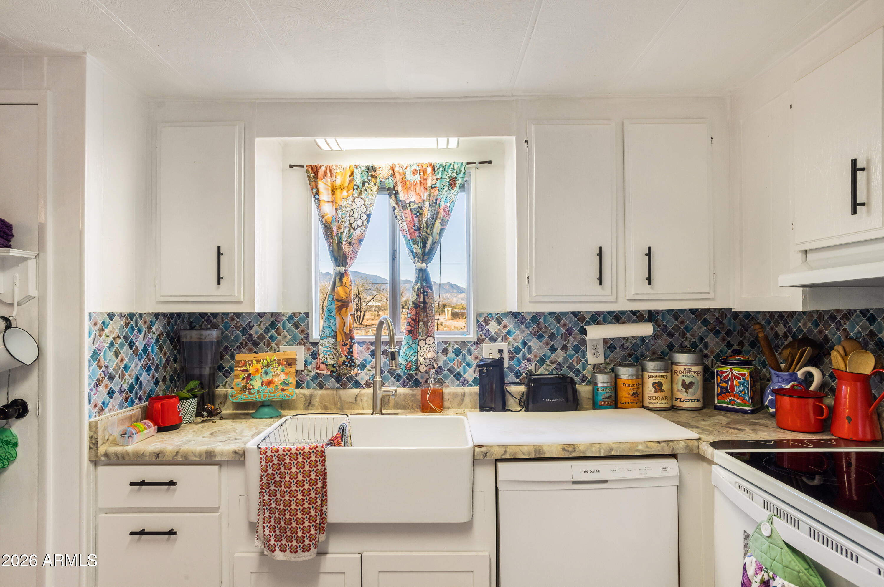 5681 South Moson Road Hereford, AZ 85615 - Photo 33 of 47 a kitchen with stainless steel appliances granite countertop a sink and a stove