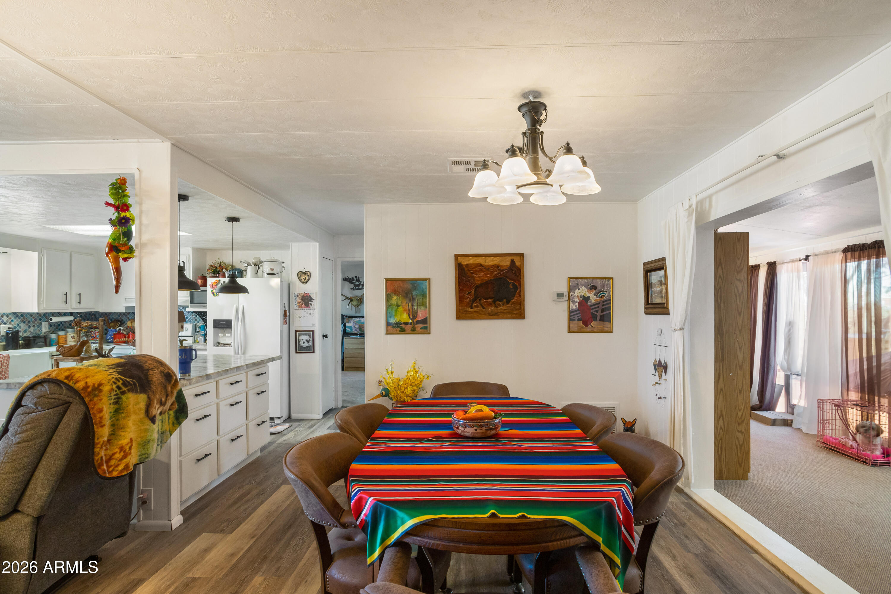 5681 South Moson Road Hereford, AZ 85615 - Photo 37 of 47 a bedroom with a bed and a chandelier