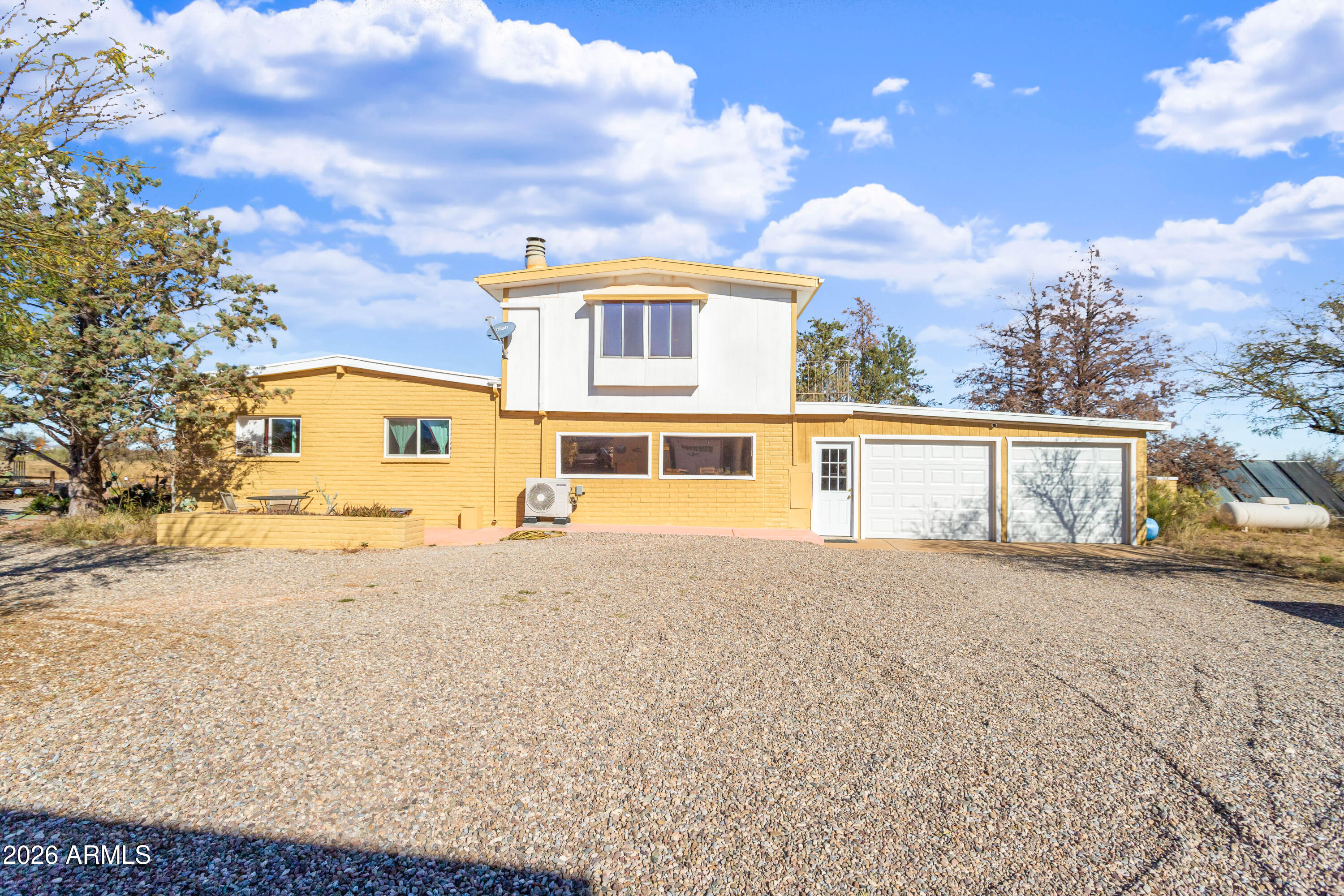 5681 South Moson Road Hereford, AZ 85615 - Photo 4 of 47 a front view of a house with a yard