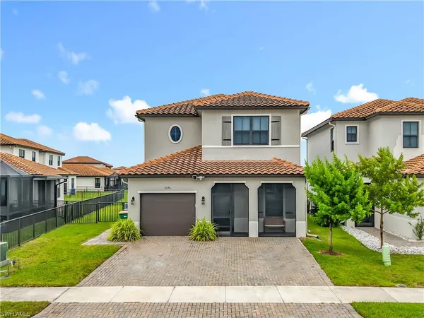 a front view of a house with a garden and plants