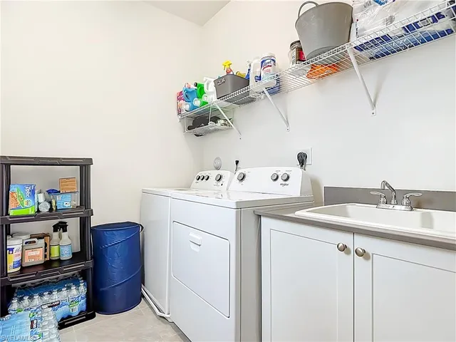a utility room with a sink washer and dryer