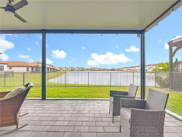 a chair and table sitting in backyard of a house