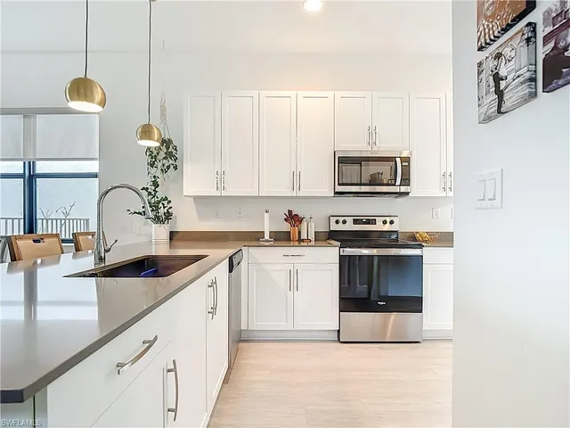 a kitchen with granite countertop a sink and a stove top oven