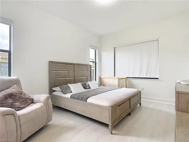 a bedroom with a bed and a couch