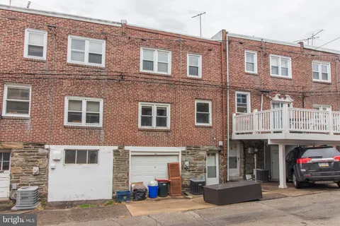 a view of a building with a cars park side of a brick building