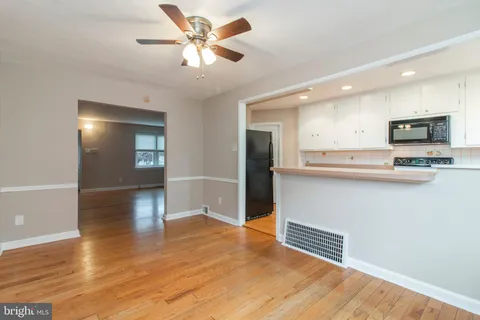 a view of kitchen with sink and wooden floor