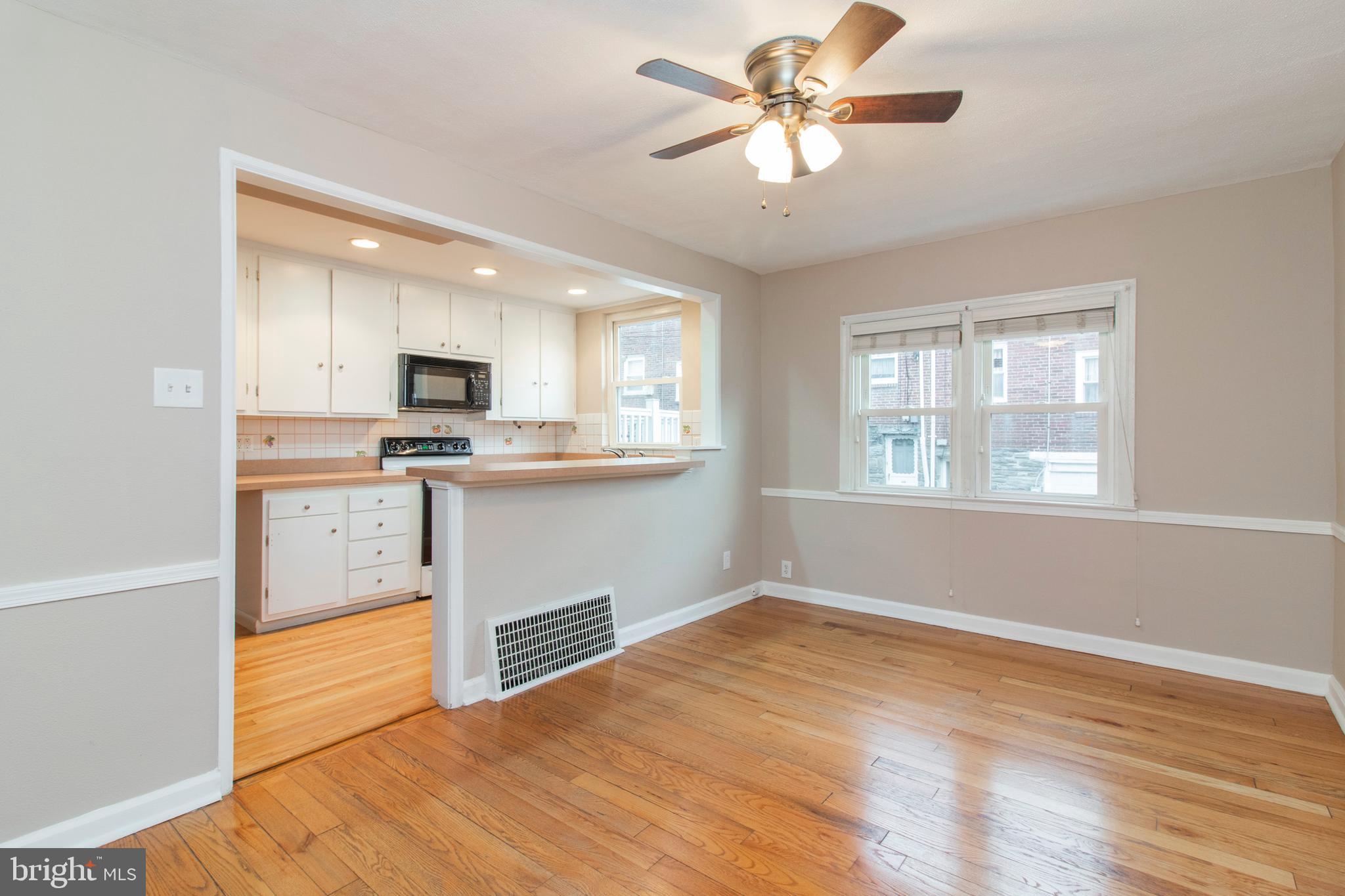 244 Barclay Road Upper Darby, PA 19082 - Photo 7 of 21 a kitchen with kitchen island a stove a sink and a microwave
