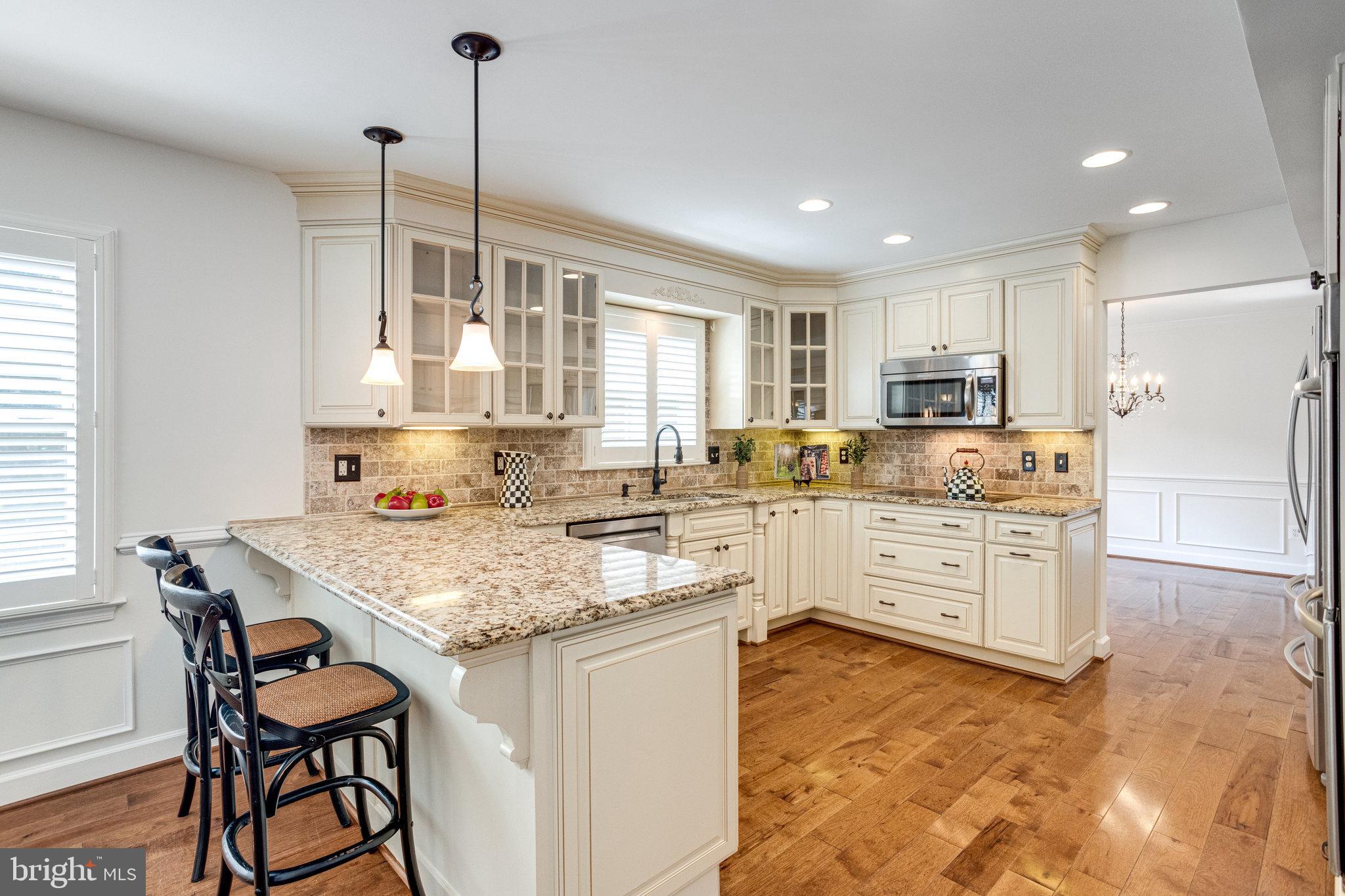 8325 Lindside Way Springfield, VA 22153 - Photo 13 of 63 Elegant glass-front cabinets and pendant lighting