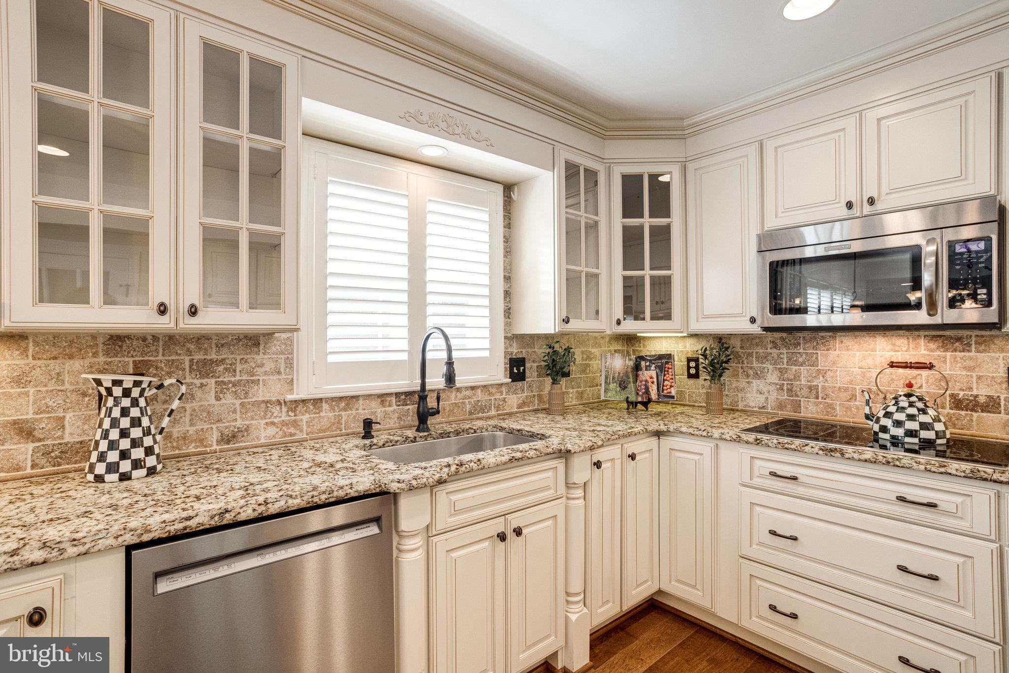 8325 Lindside Way Springfield, VA 22153 - Photo 14 of 63 Travertine backsplash and granite countertops