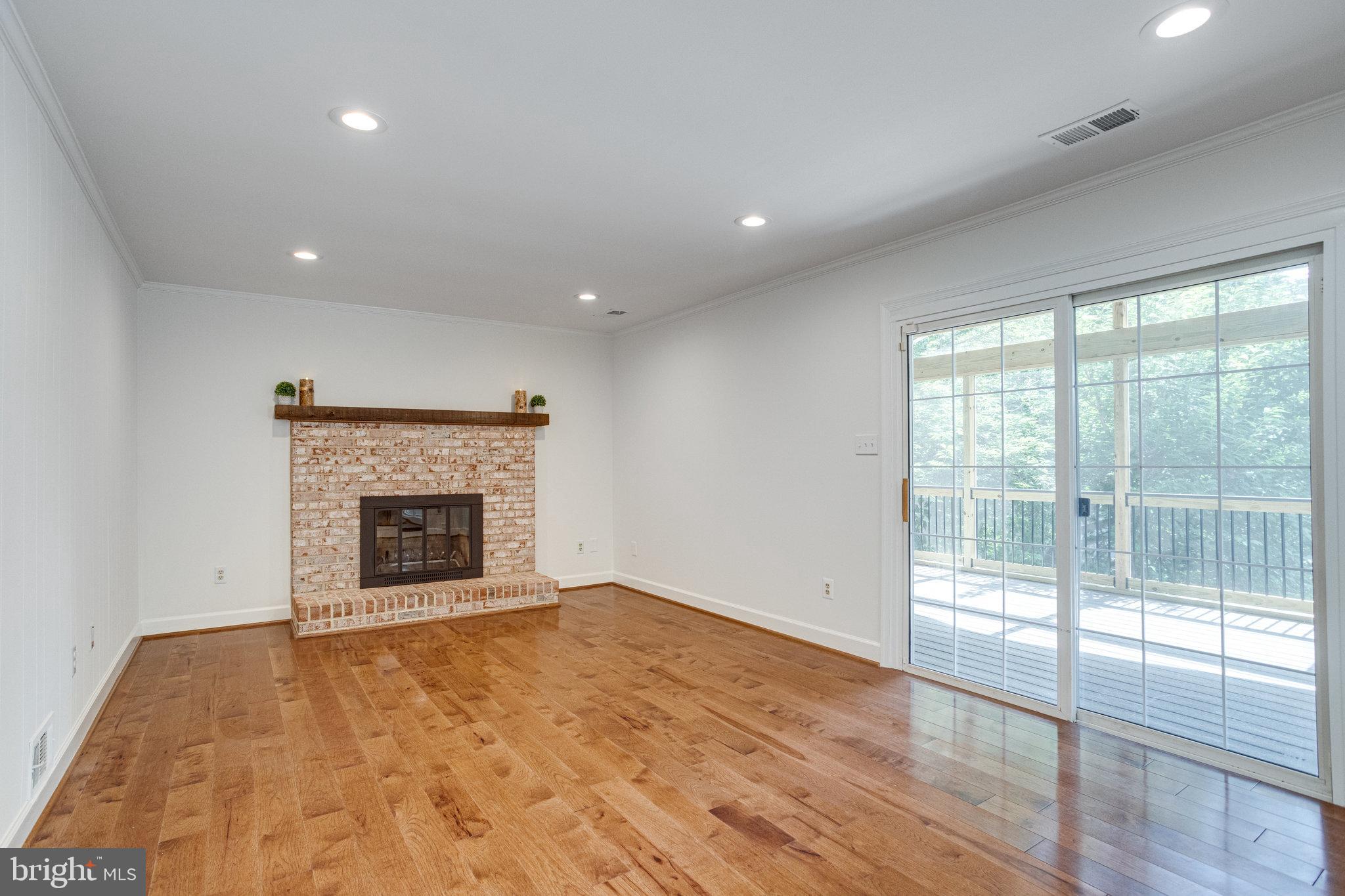 8325 Lindside Way Springfield, VA 22153 - Photo 22 of 63 Family room with fireplace & screened porch access