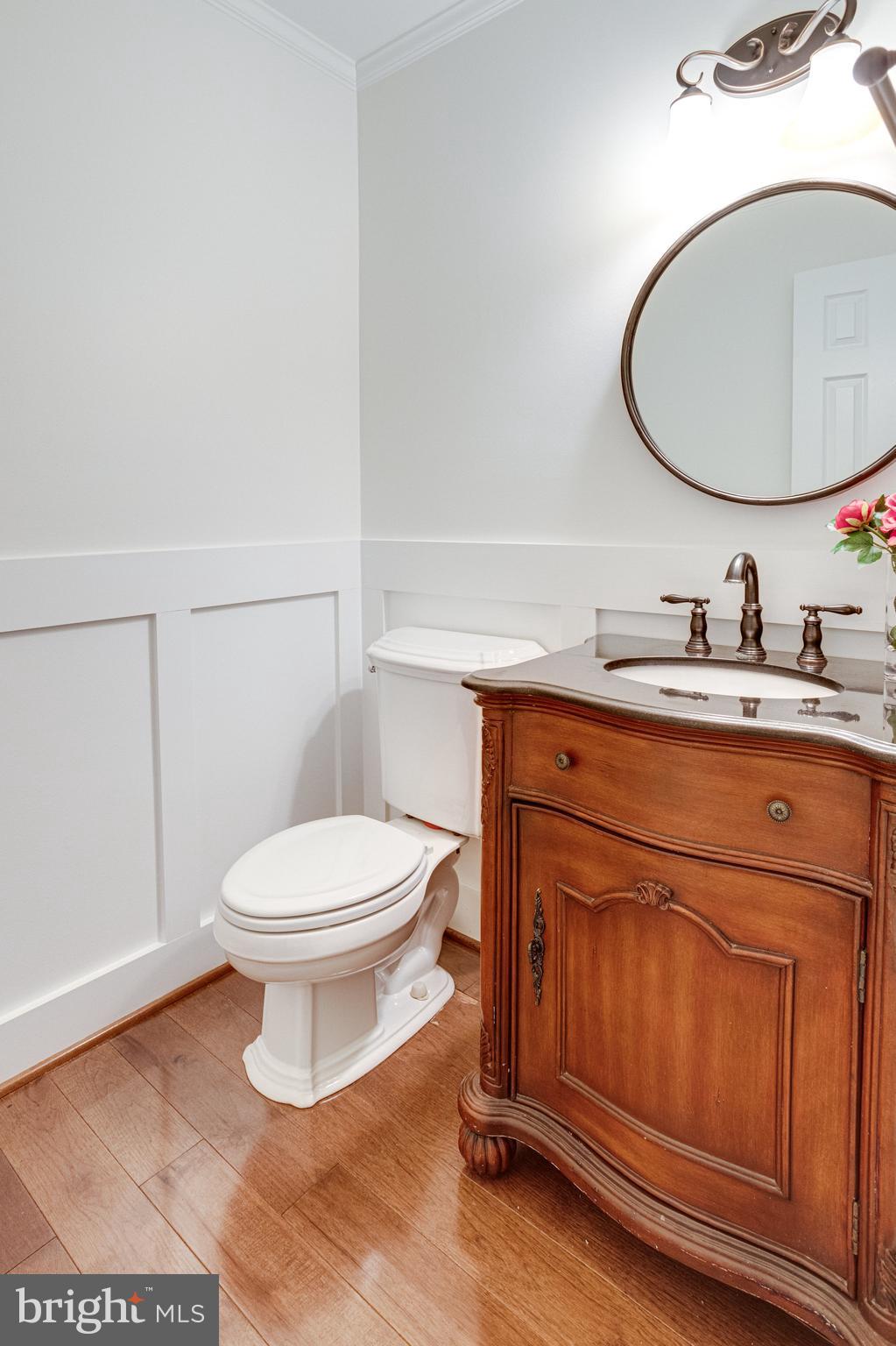 8325 Lindside Way Springfield, VA 22153 - Photo 24 of 63 Powder room with rich wood vanity and wainscoting
