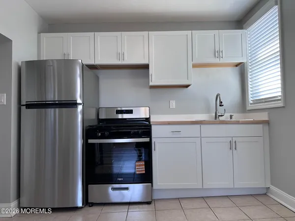 a kitchen with refrigerator sink and cabinets