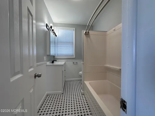 a bathroom with a bathtub a toilet and a shower