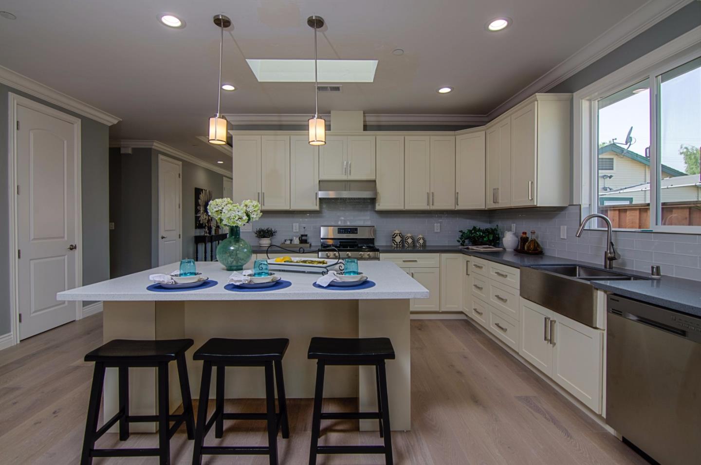847 Muender Avenue Sunnyvale, CA 94086 - Photo 6 of 15 a kitchen with stainless steel appliances kitchen island granite countertop a table chairs sink and cabinets