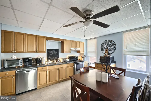 a kitchen with a table chairs and white cabinets