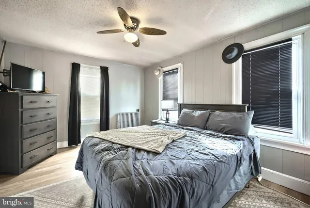 a bedroom with a bed and a tv on the dresser