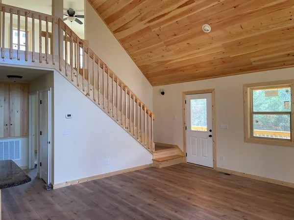 a view of an entryway with wooden floor and stairs