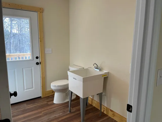 a bathroom with a toilet a sink and a mirror