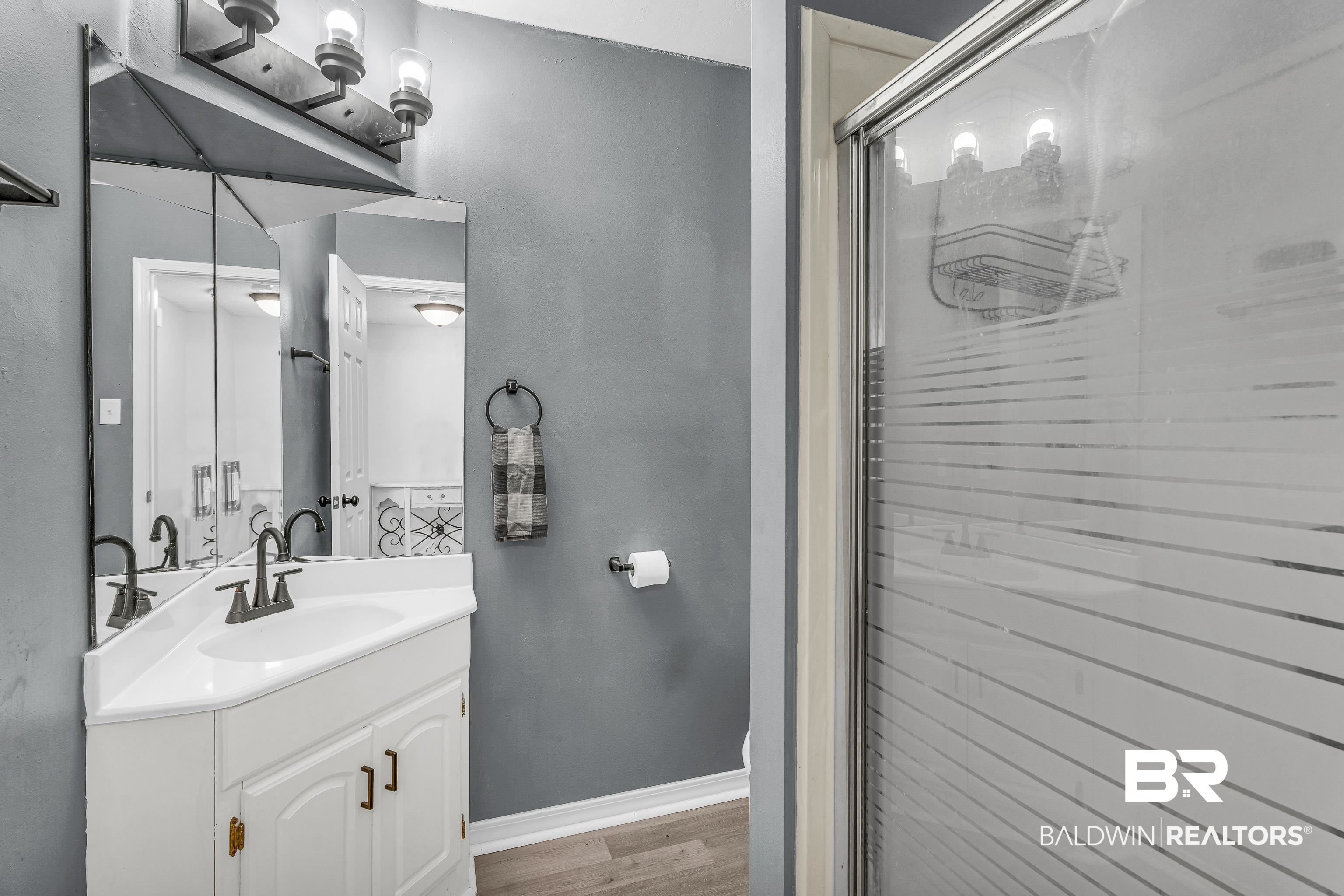 6135 Oak Cliff Drive Eight Mile, AL 36613 - Photo 16 of 30 Full bath with vanity, light wood-style floors, and a shower stall