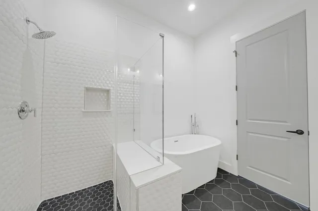 a bathroom with a bathtub and a shower