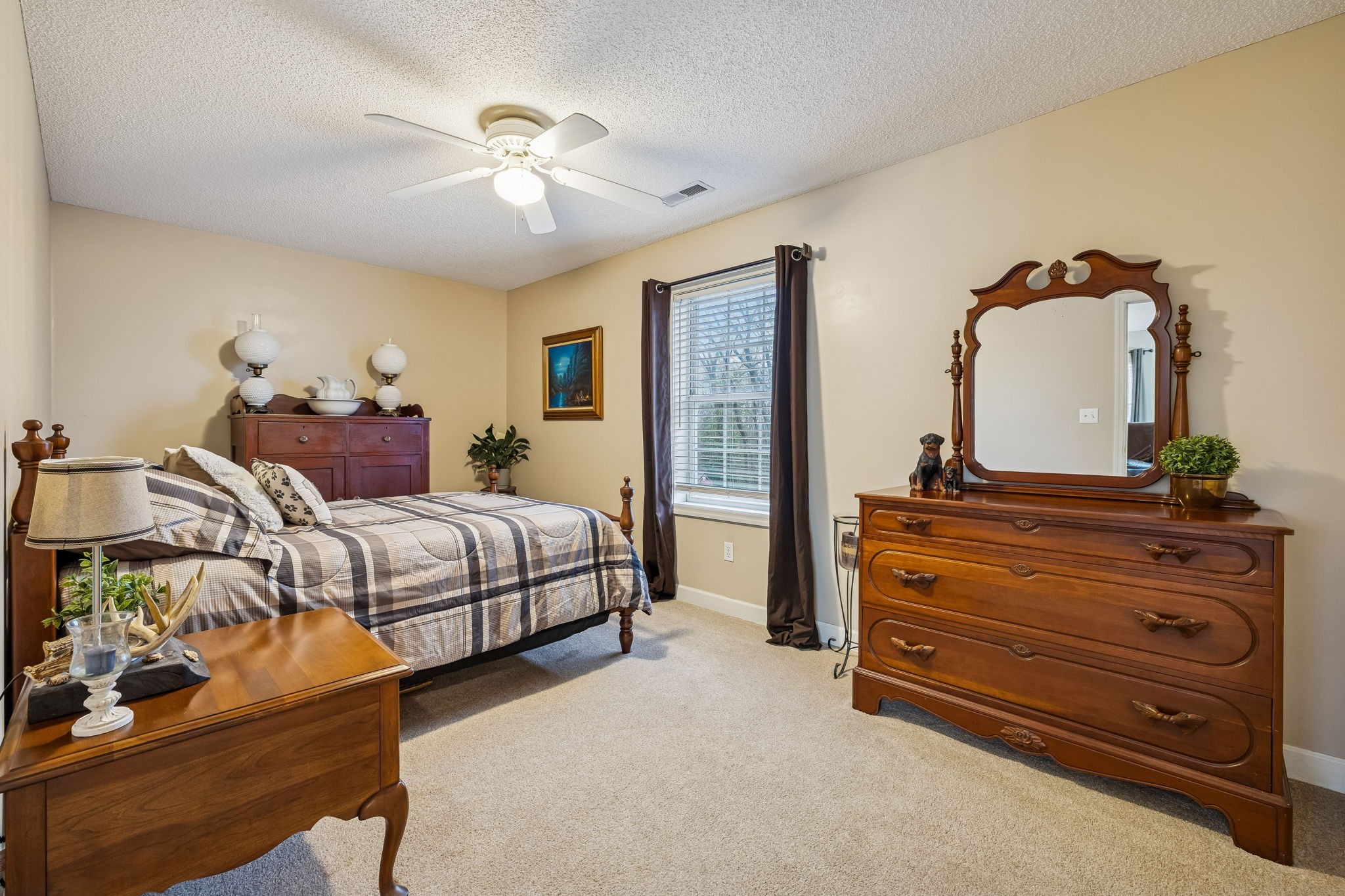 7697 Bethany Church Road Orlinda, TN 37141 - Photo 24 of 96 a bedroom with a bed and a chandelier