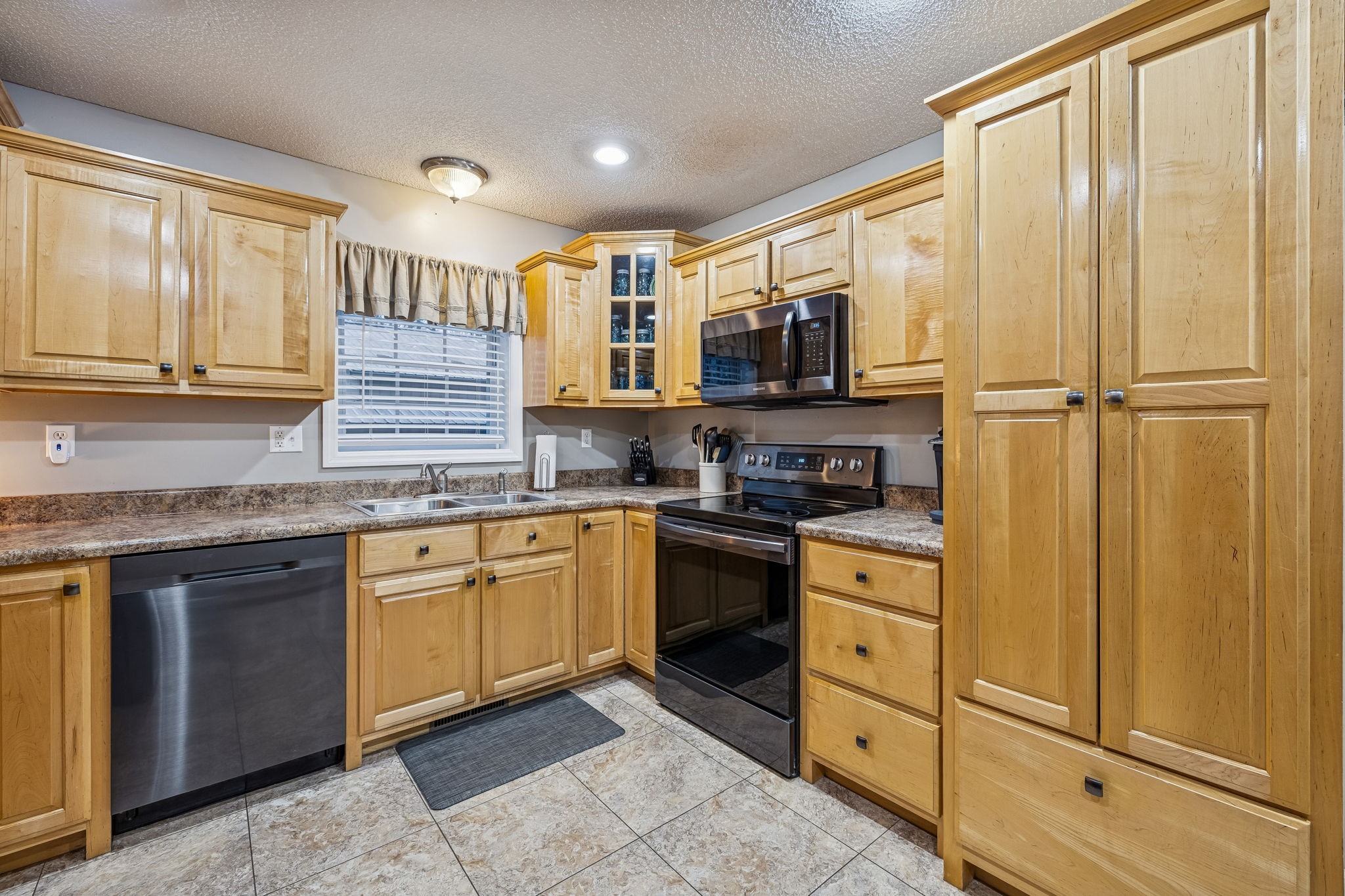 7697 Bethany Church Road Orlinda, TN 37141 - Photo 38 of 96 a kitchen with stainless steel appliances granite countertop cabinets and window