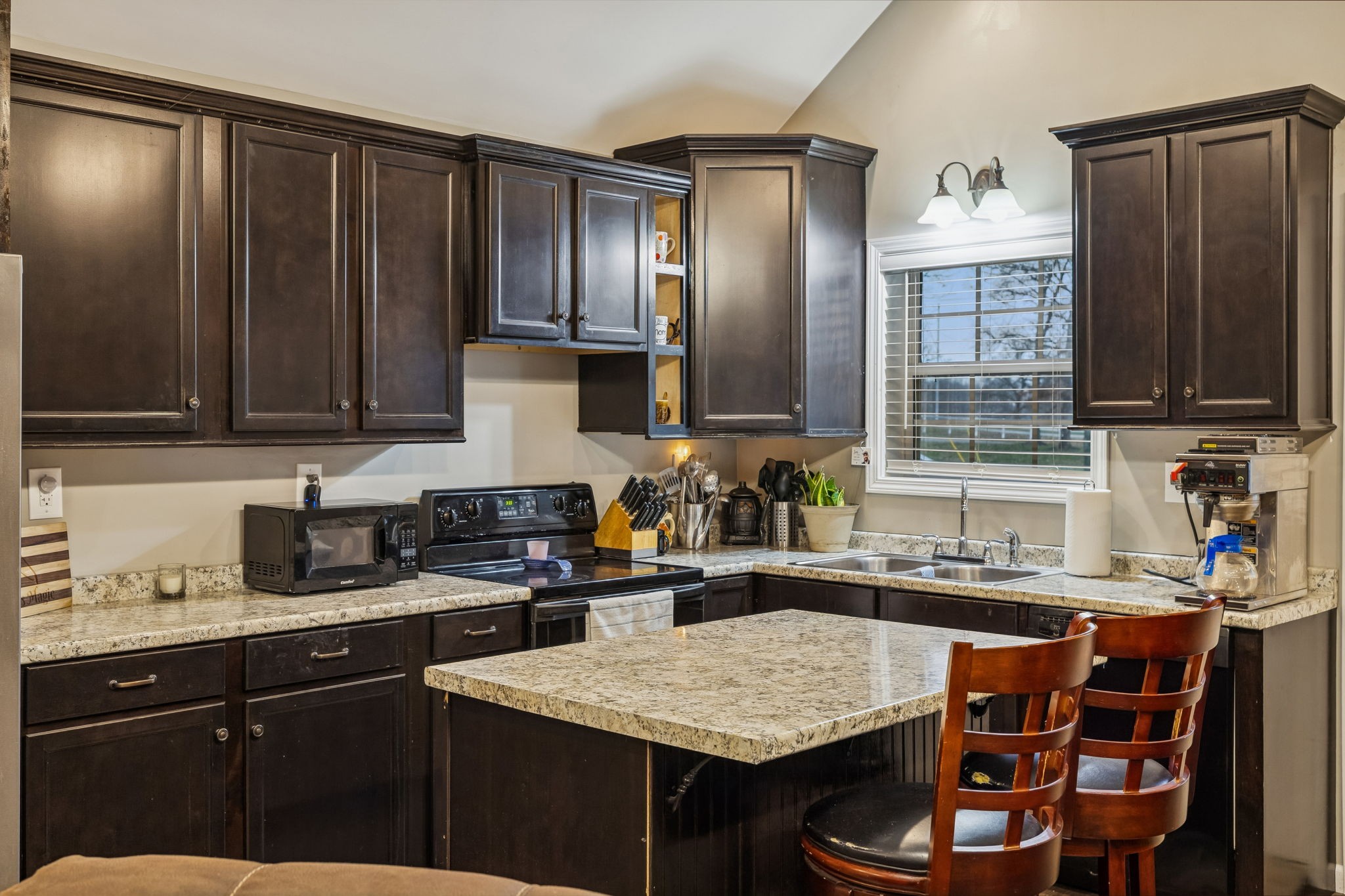 7697 Bethany Church Road Orlinda, TN 37141 - Photo 44 of 96 a kitchen with stainless steel appliances granite countertop a sink stove and refrigerator