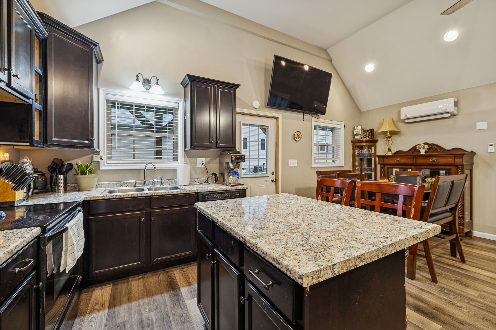 7697 Bethany Church Road Orlinda, TN 37141 - Photo 45 of 96 a kitchen with stainless steel appliances granite countertop a sink dishwasher a refrigerator and a stove with wooden floor