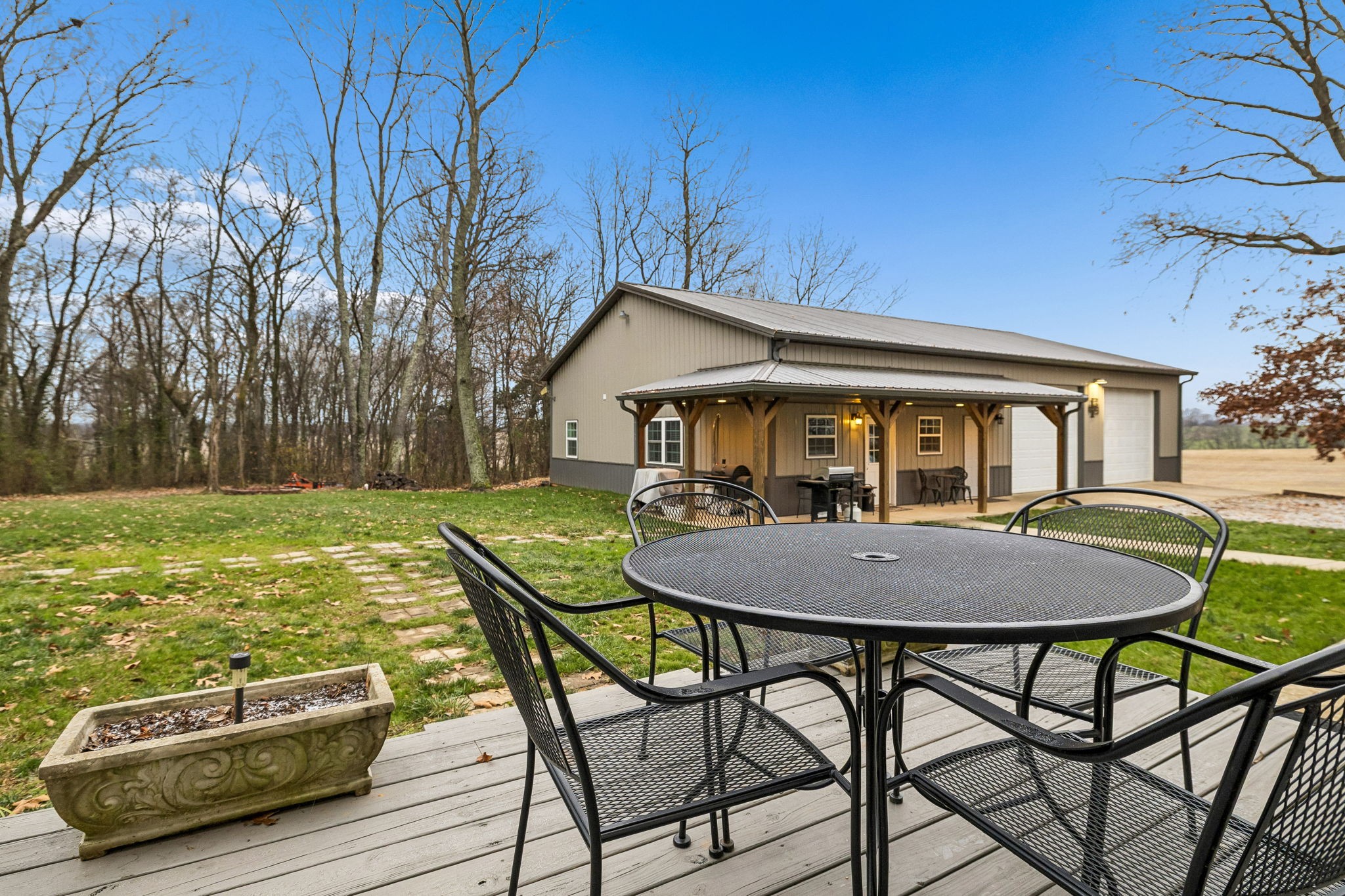 7697 Bethany Church Road Orlinda, TN 37141 - Photo 66 of 96 a view of a house with backyard table and chairs