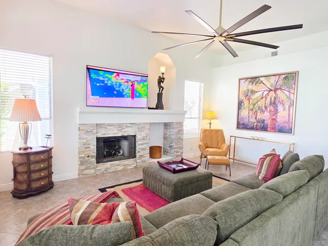 a living room with furniture and a fireplace